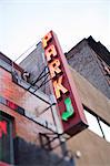 Neon parking sign on building