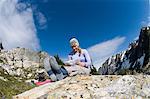 Woman reading map at camp, Picket Pass, North Cascades National Park, Washington State, USA