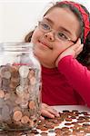 Young girl with jar full of coins