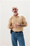 Mature man with hands clasped, studio shot