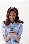 African American teenage girl using cellphone, studio shot