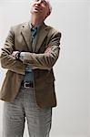 Mature man looking up and smiling, studio shot