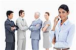 Close-up of a multicultural business team talking and a woman making a call in foreground