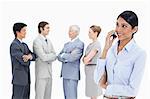 Close-up of a multicultural business team talking focus on a woman making a call in foreground