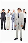 Multicultural business team with their thumbs-up focus on a smiling man in foreground against white background