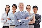 Close-up of a smiling multicultural business team behind their boss in a low-angle shot against white background