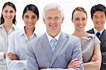 Close-up of a multicultural business team smiling behind their boss against white background