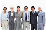 Close-up of multicultural business team arm in arm against white background