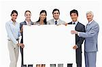 Close-up of a multicultural business team holding a big placard white against white background