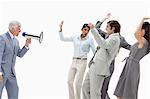 Man yelling in a megaphone at business people against white background