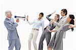 Man yelling in a megaphone at stunned business people against white background