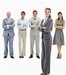 Blonde woman with business people smiling behind her against white background