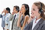 Professionals listening with headsets against white background