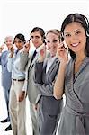 Call centre with smiling people against white background