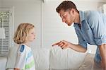 Son looks out the window as his father punishes him for misbehaving