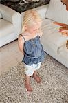 A child being punished by her mother looks to the floor to avoid her mothers stare