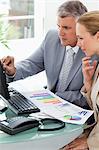 Business people working on statistical report in an office