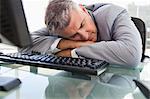 Businessperson sleeping on his desk in his office