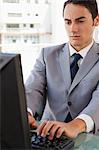 Businessman working on his computer in a bright office