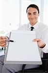 Smiling businessman showing a file in a bright office