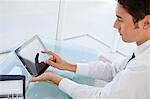 Businessman using a touch pad in a bright office