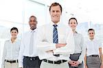 Smiling businessman with his arms crossed together with his team