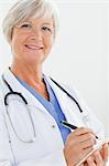 Close up of smiling mature doctor with notepad