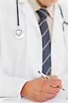 Close up of prescription being filled by male doctor