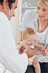 Doctor taking little babys heart beat