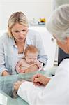 Mother with her little baby seeing the doctor