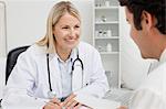 Smiling female doctor talking to her patient