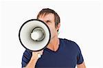 Furious man holding a megaphone while standing up against a white background