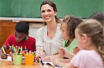 Smiling elementary teacher giving art class