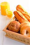 Assorted Bread Rolls In Wooden Tray And Orange Juice