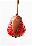 Chocolate Dropping On Strawberry With White Background In Behind