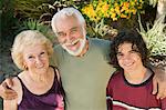 Teenage boy (13-15) with grandparents outdoors, elevated view portrait.