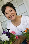 Woman with flowers, outdoors, (portrait)