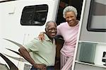Senior couple with motor home, (portrait)