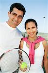 Mixed doubles Tennis Players standing on tennis court, portrait