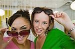 Two Girls Trying on Sunglasses in Boutique, portrait, close up