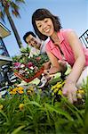 Couple gardening, (low angle view)