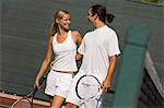 Mixed Doubles Partners standing on Court, arms around