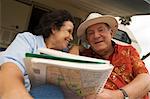 Couple with map book outside motor home