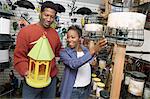 Couple choosing birdhouse in shop
