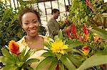 Couple choosing plants at nursery, (portrait)