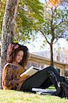 Female student studying under tree