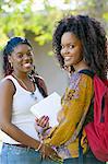 Two female students smiling, outdoors, (portrait)