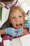 Girl (7-10) having teeth examined at dentists