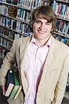 Male University student in library, portrait