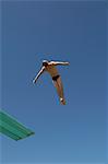 Man diving from diving board, mid air
